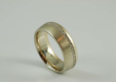 White and rose gold ring with matte finish and channel set diamonds