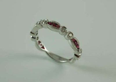 White gold women's wedding band with ruby and diamond with scalloped edge