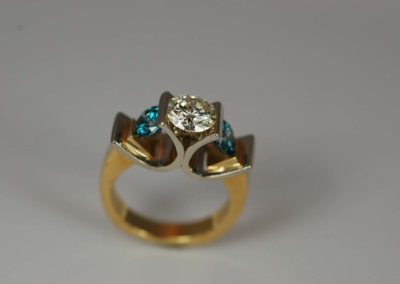 Custom designed 14 kt yellow and white gold ring with white diamond and blue diamond