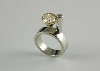Platinum and 18 kt yellow gold bezel set diamond ring