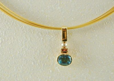 blue topaz pendant in 14kt yellow and white gold