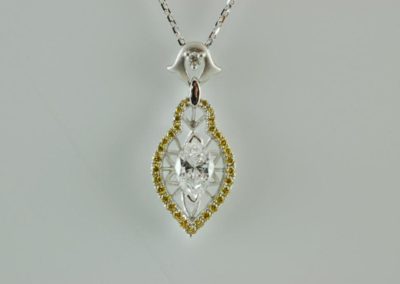 white center diamond with yellow diamonds pendant in 18kt white gold
